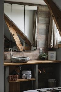 a bathroom with a mirror and a sink at La Bastide de Barbizon in Barbizon