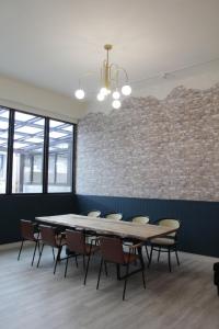 a conference room with a table and chairs and a brick wall at 嫚悅文旅 in Dayi