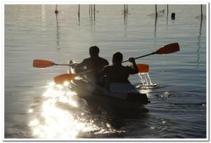two people are in a boat on the water at Domek Natalia in Giżycko