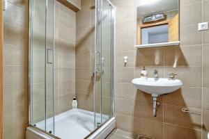 a bathroom with a sink and a shower at Sigma apartment in Budva +11 photos