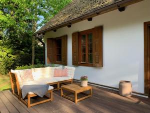 a patio with a table and chairs on a deck at AŻ POD LAS in Zbiczno