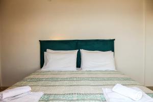 A bed or beds in a room at Clios House