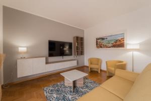 a living room with a couch and a tv at Angela Suite in Portoferraio