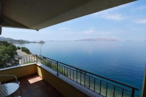 a balcony with a view of a body of water at Accommodation Salvia in Sveti Juraj