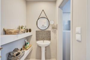 a bathroom with a sink and a mirror at Old Town Luxury Velvet Apartment in Rhodes Town