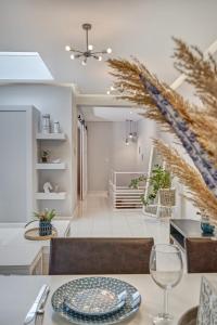 a living room with a dining table and a staircase at Old Town Luxury Velvet Apartment in Rhodes Town