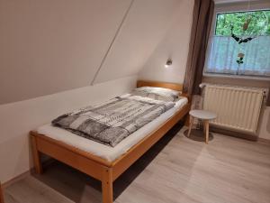 a small bed in a room with a window at Ferienhaus Marie 125 in Bad Arolsen