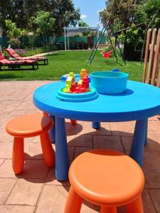 a blue table and two stools with a toy on it at Chalet Las Dalias in El Espinar
