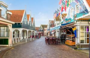 an empty street in a town with tables and chairs at Luxury loft at lake Volendam 20 min. from Amsterdam CS in Volendam