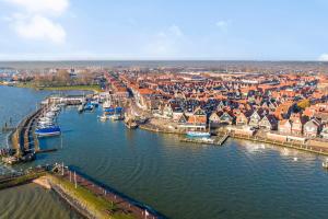 an aerial view of a city with boats in the water at Luxury loft at lake Volendam 20 min. from Amsterdam CS in Volendam