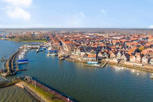 an aerial view of a city with boats in the water at Luxury loft at lake Volendam 20 min. from Amsterdam CS in Volendam