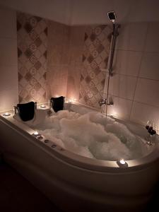 a bath tub with lights in a bathroom at La Mary in Old Town in Sibiu +24 photos