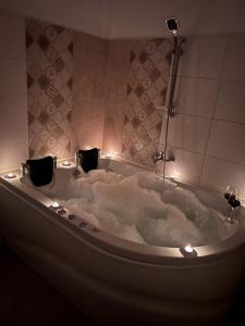 a bath tub with lights in a bathroom at La Mary in Old Town in Sibiu