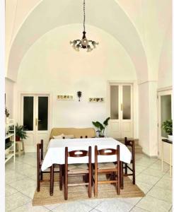 a dining room with a white table and chairs at Dimora Galerana, Oria città del Salento in Oria