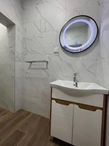 a bathroom with a sink and a mirror on the wall at Azzure Apartment in Ulcinj