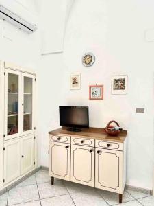 a living room with a tv and a table with a tv at Dimora Galerana, Oria città del Salento in Oria