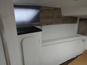a small kitchen with white cabinets and a window at BED&BOAT II boatandholiday com in Fano +5 photos