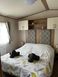 a bedroom with a bed with two pillows on it at Uisge Beatha in Dornoch