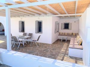 a patio with a couch and a table and chairs at Quiet 2-bedroom sea view villa with shared pool in Mármara