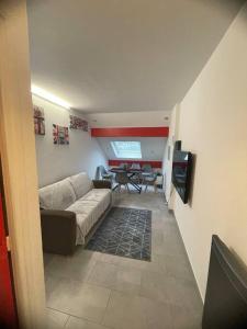 a living room with a couch and a table at Superbe appartement Disneyland Paris Parking in Lagny