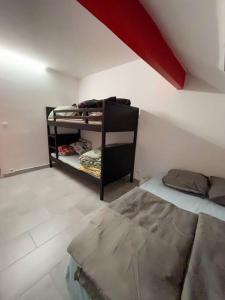 a room with two bunk beds and a red roof at Superbe appartement Disneyland Paris Parking in Lagny