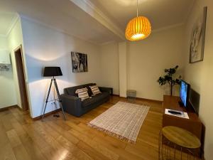 a living room with a couch and a table at Apartamentos da Carreira in Funchal