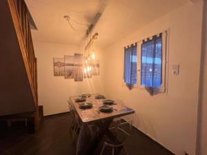 a room with a table in the corner of a room at delille pere et fils in Albertville