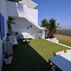 a backyard with a lawn with a couch and chairs at Tu Casina del Norte in Luanco +48 photos