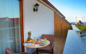 a small table on a balcony with a bowl of fruit at ALMIRCAN HOTEL in Trabzon