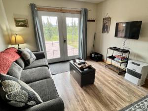 a living room with a couch and a flat screen tv at Denali Park 2 Bedroom Mom in Law in Healy