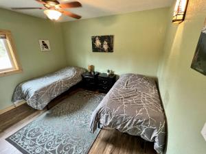 a bedroom with two beds and a ceiling fan at Denali Park 2 Bedroom Mom in Law in Healy