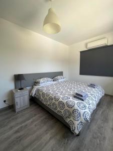 a bedroom with a bed and a tv on the wall at Polyxeni Hotel Apartments in Limassol