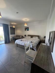 a bedroom with a bed and a table and chairs at Polyxeni Hotel Apartments in Limassol