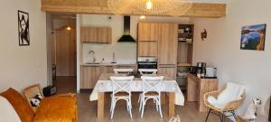 uma cozinha com mesa e cadeiras num quarto em Appt à Ancelle pied des pistes em Ancelle