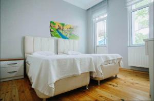 a bedroom with a large bed with a white blanket at Windrose Hostel Istanbul in Istanbul