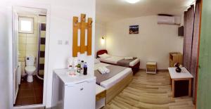 a small room with a bathroom with a bed and a sink at Casa Georgeta 2 Mai-Punct Gastronomic Local-AROME DOBROGENE in 2 Mai
