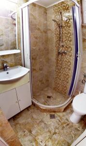 a bathroom with a shower and a sink and a toilet at Casa Georgeta 2 Mai-Punct Gastronomic Local-AROME DOBROGENE in 2 Mai +40 photos