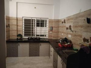 a kitchen with a counter and a sink and a window at Diva Villa in Dabok