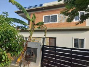 a palm tree in front of a house at Diva Villa in Dabok