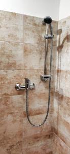 a shower with a hose attached to a wall at Caravel Appartamentini in Lido di Camaiore +106 photos