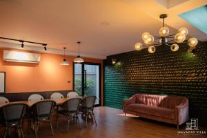 a conference room with a table and chairs and a couch at Navagio Villa 