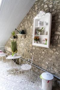 a room with chairs and a cabinet with plants in it at Domus Fontis Pescaia in Spoleto