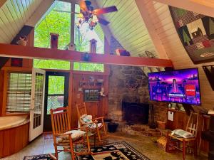 a living room with a stone fireplace in a house at Buckberry Creek Chalet in Gatlinburg