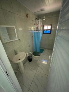 a small bathroom with a sink and a toilet at Recanto do Paraiso in Peruíbe