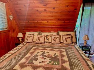 a bedroom with a large bed with a wooden headboard at Buckberry Creek Chalet in Gatlinburg