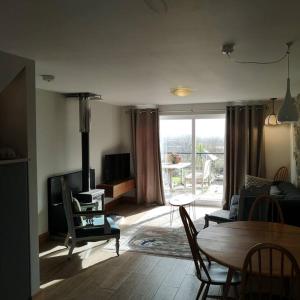 a living room with a table and a couch at Hide on the Hill Cottage in Wells +32 photos