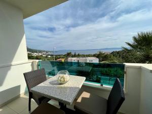 a table with chairs and a glass bowl on a balcony at Apartments Casabrillantin in Tučepi