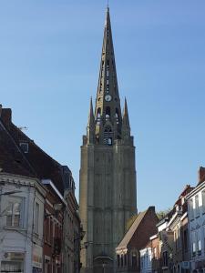 a tall building with a clock tower in a city at La colombe 43 in Steenvoorde