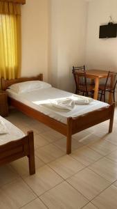 a bedroom with a bed and a table and a table and chairs at Vila 3 in Himare