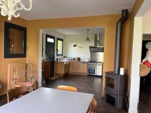 a kitchen with a table and a stove at Grande maison Quiberonnaise capacité jusqu'à 8 personnes in Quiberon